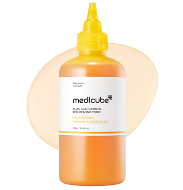 Orange-toned toner bottle with yellow cap on a white background, featuring Medicube branding, Medicube Kojic Acid Turmeric Resurfacing Toner 250ml