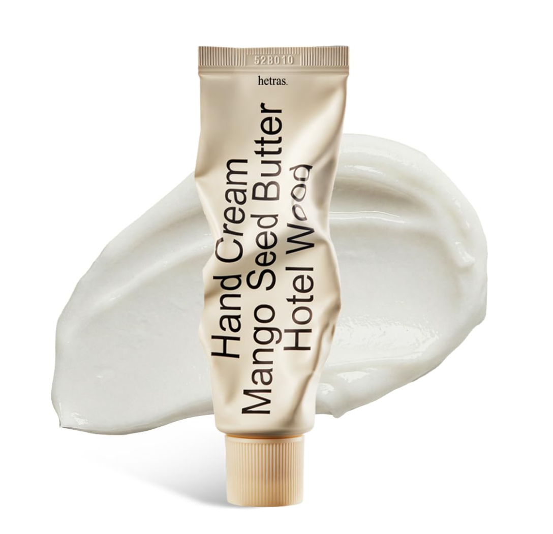 Hand cream tube labeled 'Mango Seed Butter' with a swatch of cream on a white background, Hetras Hand Cream Mango Seed Butter Hotel Wood 50ml