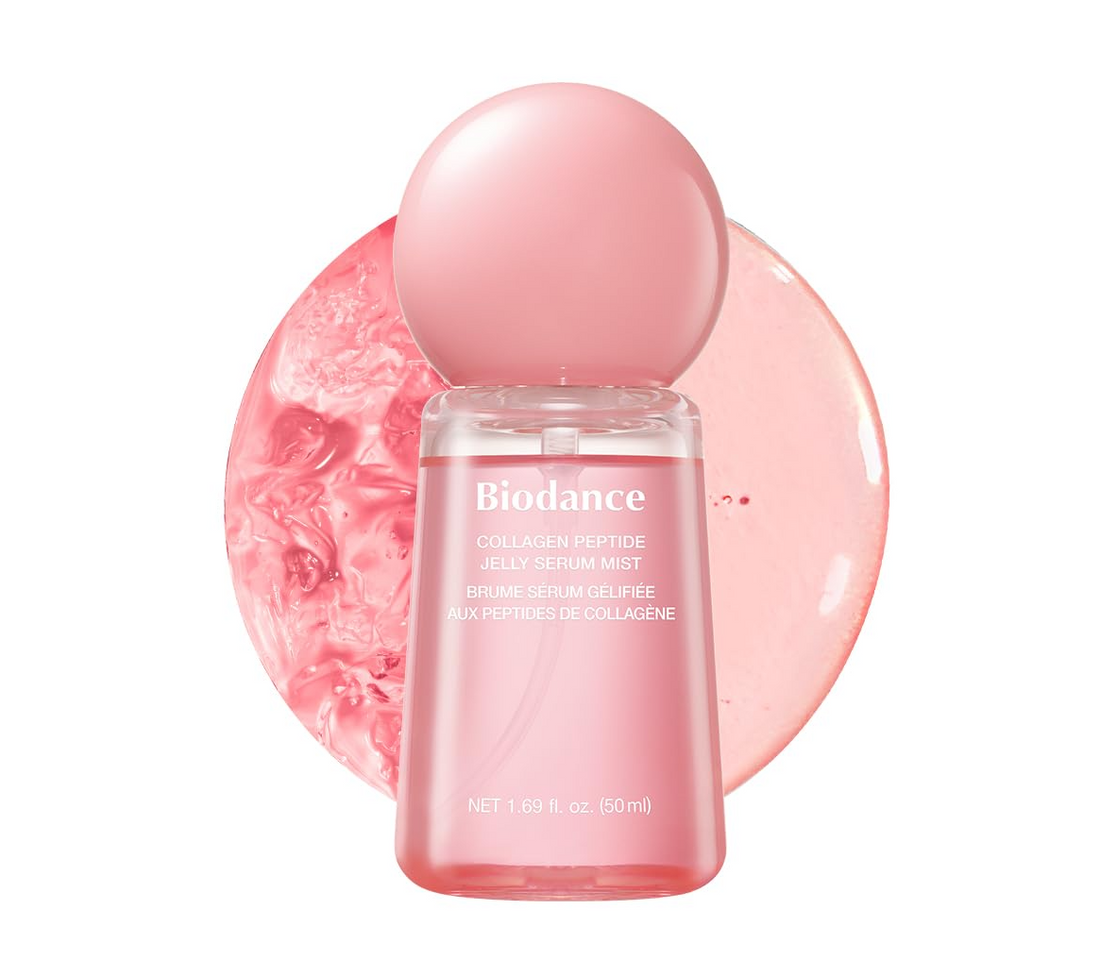 Biodance Collagen Peptide Jelly Serum Mist in a clear bottle with a pink spherical cap, set against a pink circular gel texture on a white background, Biodance Collagen Peptide Jelly Serum Mist 50ml