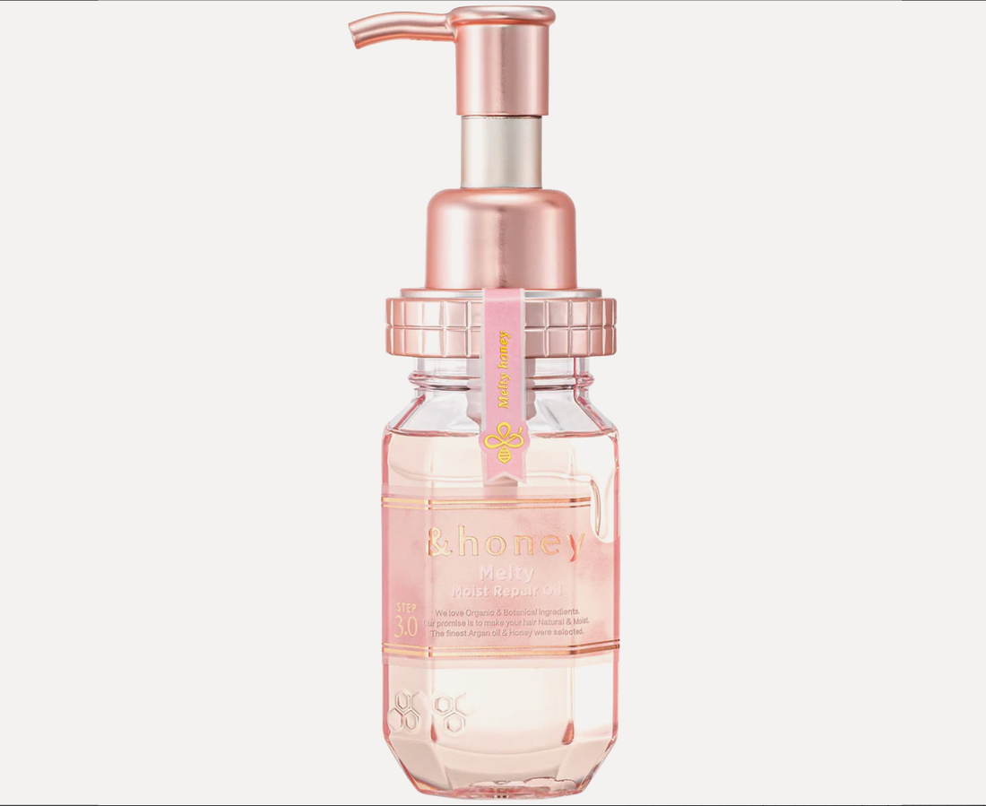 Clear bottle with pink liquid and rose gold pump on a white background, &Honey Melty Moist Repair Oil 100ml