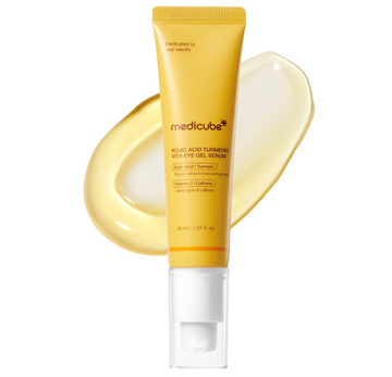 A squeeze tube of medicube Mollic Acid Turmeric + Eye Gel Serum in a golden yellow color with a clear cap, shown against a white background with a translucent smear of the gel behind it, MEDICUBE Kojic Acid Turmeric Vita Eye Gel Serum 30ml