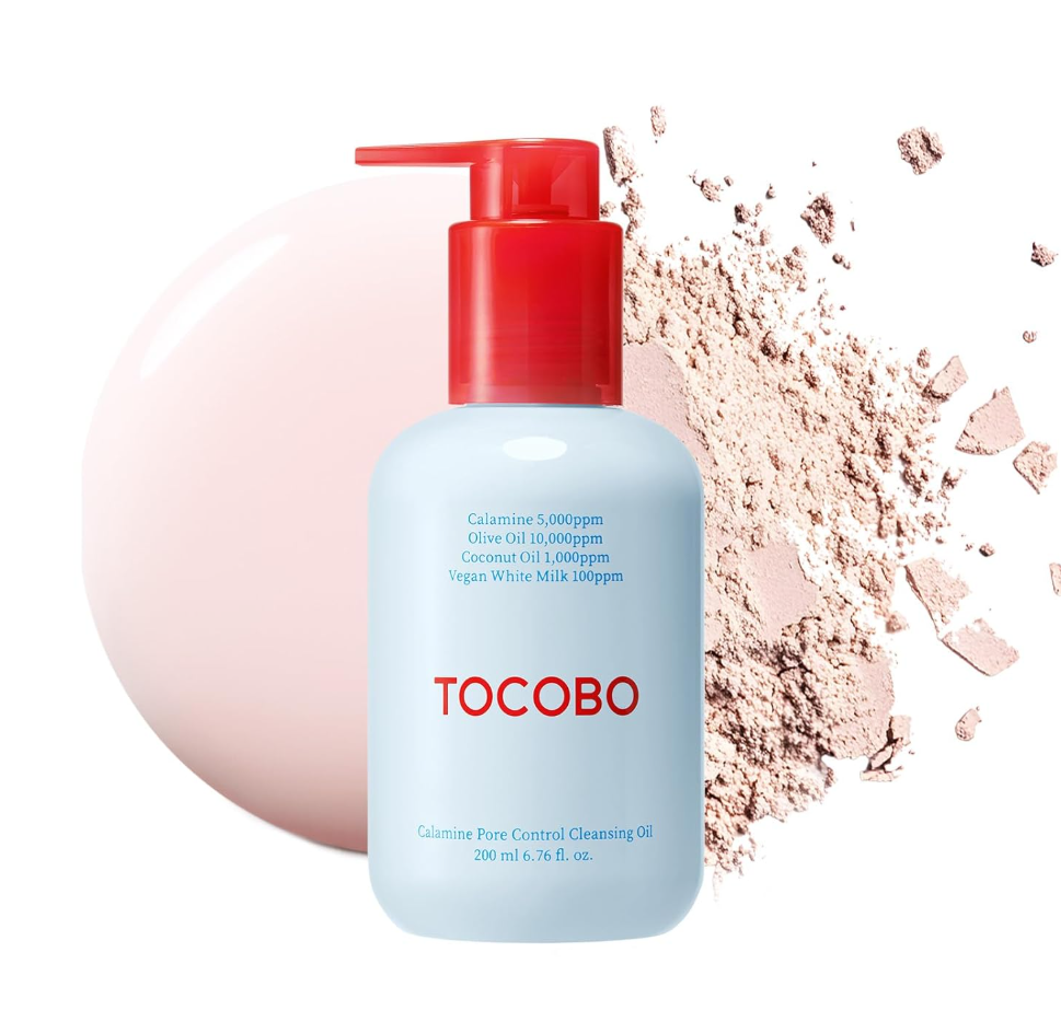 A bottle of TOCOBO Calming Pore Control Cleansing Oil with a red pump and a light blue body, shown against a white background with a soft pink circular shape and cosmetic powder scattered behind it. TOCOBO Calamine Pore Control Cleansing Oil 200ml