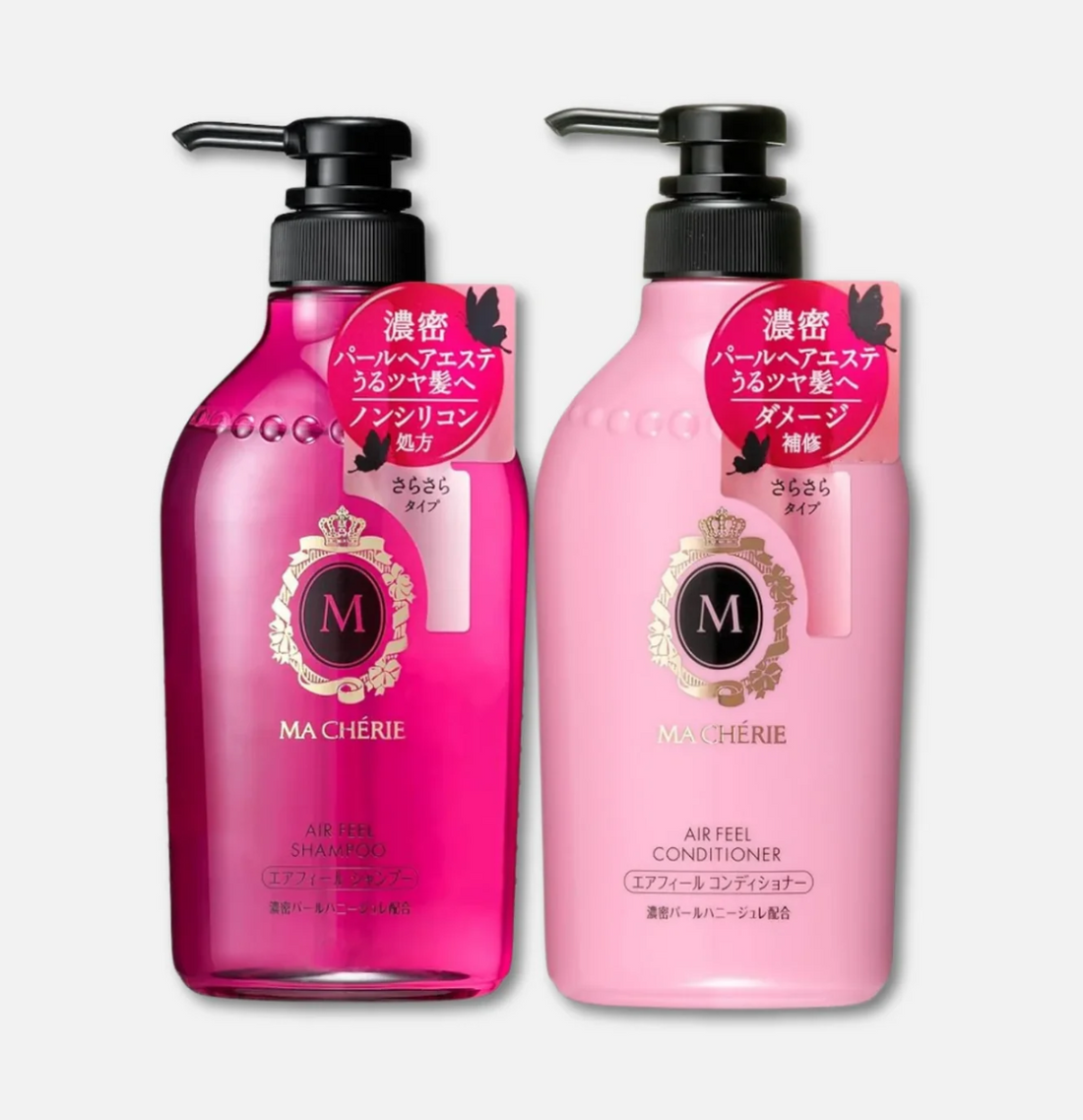 Two Ma Cherie hair care bottles on a light gray background: a darker pink shampoo bottle on the left and a lighter pink conditioner bottle on the right, both with black pump tops and a red circular Japanese label.