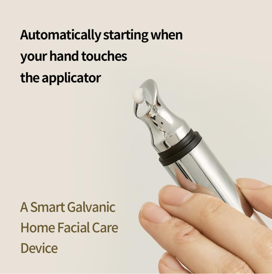 Smart galvanic home facial care device held by a hand with text on a beige background, Heveblue Black Yuja Bean Lifting Auto Eye Cream 15ml