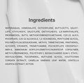 A close-up of a white cosmetic or skincare product surface with the word 'Ingredients' in dark gray text and a block of ingredient names printed below. Dr. Althea Green Tea Calming Sunscreen 50ml