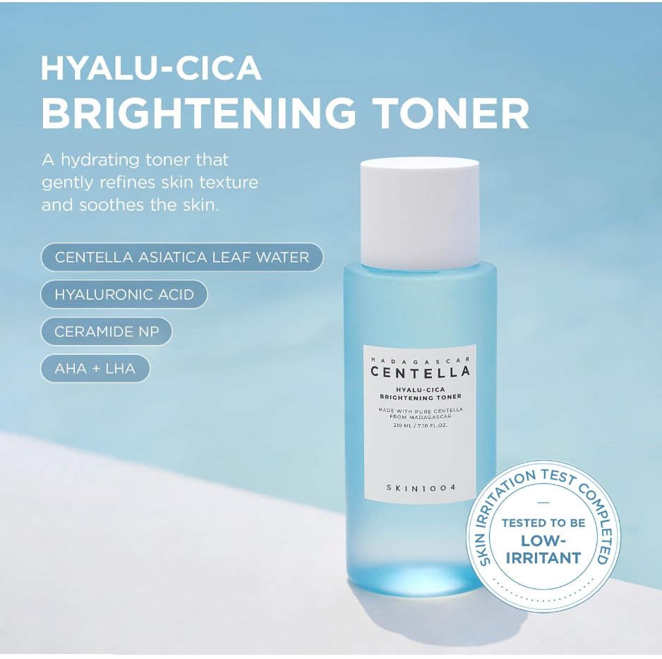SKIN004 Hyalu-Cica Brightening Toner bottle on a light blue background with product text and feature callouts. The bottle is translucent light blue with a white cap and white label. Skin1004 Madagascar Centella Hyalu-Cica Brightening Toner 210ml
