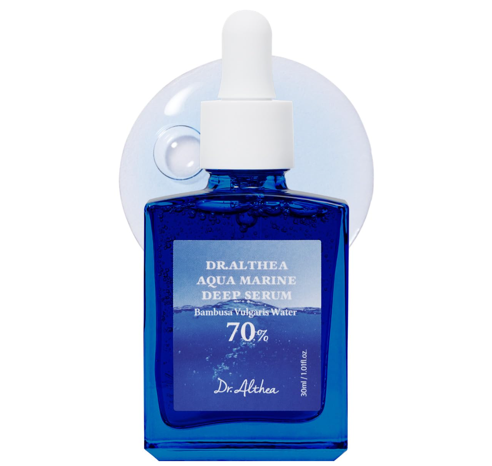 Dr. Alpha Dralthea Aqua Marine Deep Serum in a cobalt blue glass bottle with a white dropper cap, shown against a white background with a translucent bubble graphic behind it. Dr. Althea Aqua Marine Deep Serum 30ml