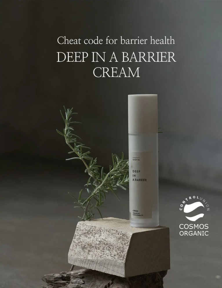 Cosmetic cream bottle with rosemary on a stone block against a dark background, featuring Cosmos Organic logo, Sioris Deep In a Barrier Cream 50ml