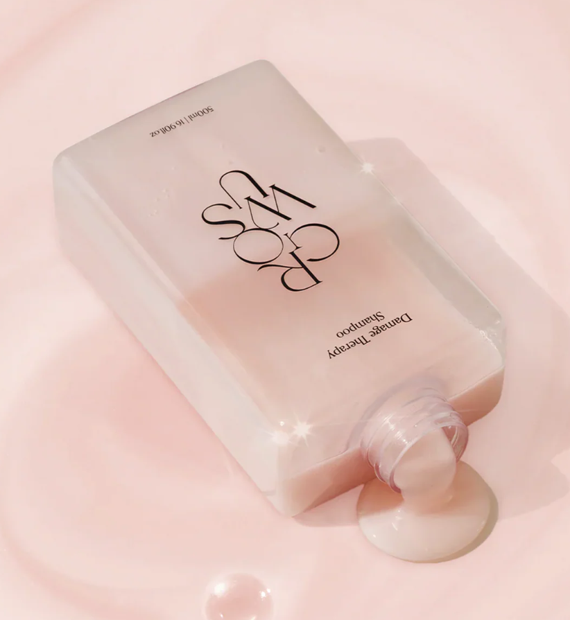 Skincare bottle with visible brand name on a pink background, Growus Damage Therapy Shampoo EX 500ml