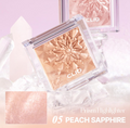 Clio Prism Highlighter in Peach Sapphire on a light pink background, Clio Prism Highlighter 5 Peach Sapphire 8g