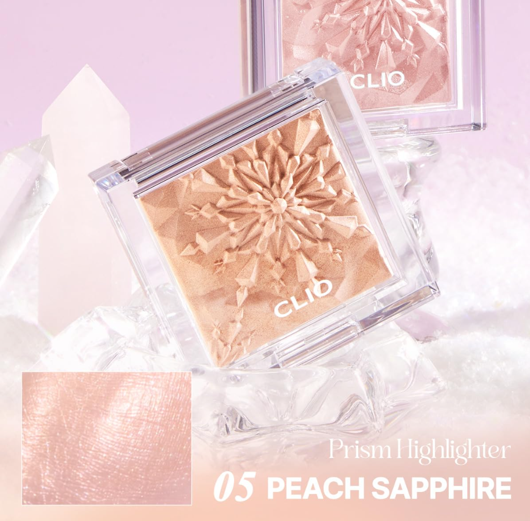 Clio Prism Highlighter in Peach Sapphire on a light pink background, Clio Prism Highlighter 5 Peach Sapphire 8g