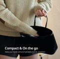 Person holding a black handbag with text about hand care, Hetras Hand Cream Mango Seed Butter Hotel Wood 50ml