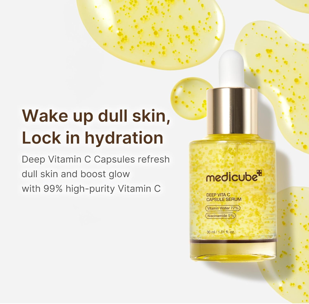 Medicube Deep Vitamin C Capsule Serum in a clear dropper bottle filled with golden-yellow serum, shown on a white background with decorative yellow serum droplets and marketing text, Medicube Deep Vita C Capsule Serum 30ml