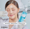 Person holding a COSRX skincare product with a laboratory setting in the background, COSRX Low pH Niacinamide Micellar Cleansing Water 400ml