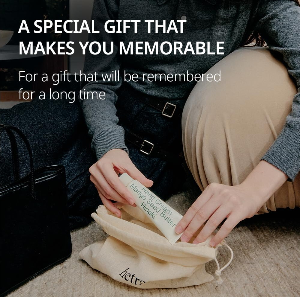 Person holding a product with text about a special gift, Hetras Hand Cream Mango Seed Butter Hinoki 50ml